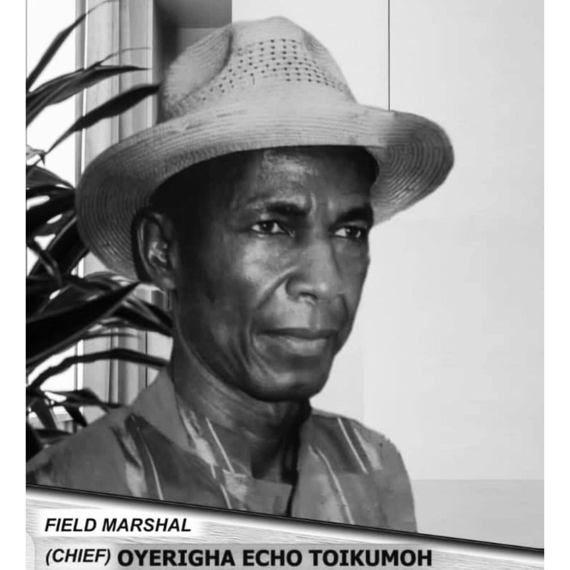 Black and white portrait of Chief Oyerigha Echo Toikumoh wearing a hat